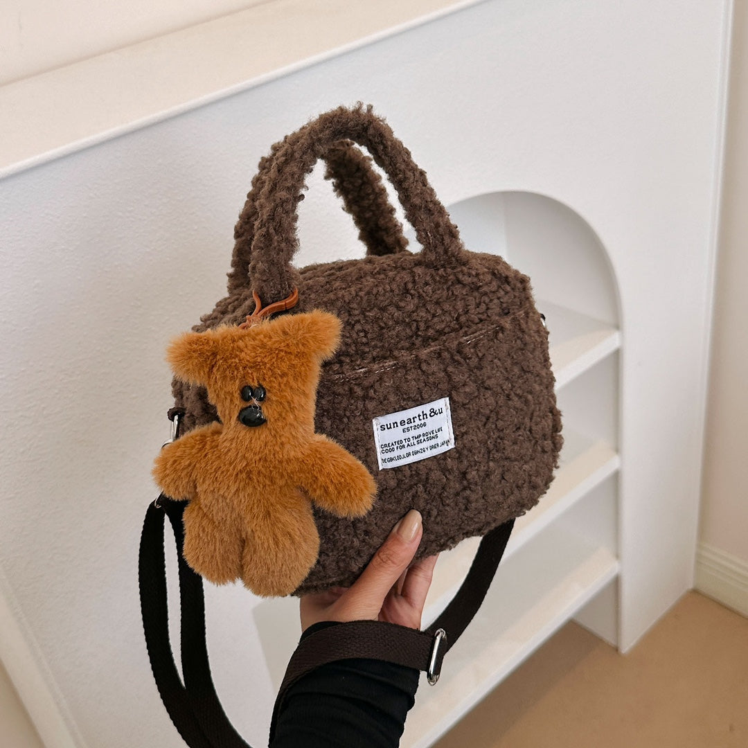 Adorable fluffy handbag available in four different colors, comes with a cute teddy bear pendant as a gift.