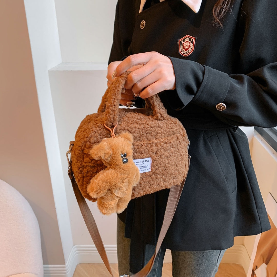 Adorable fluffy handbag available in four different colors, comes with a cute teddy bear pendant as a gift.
