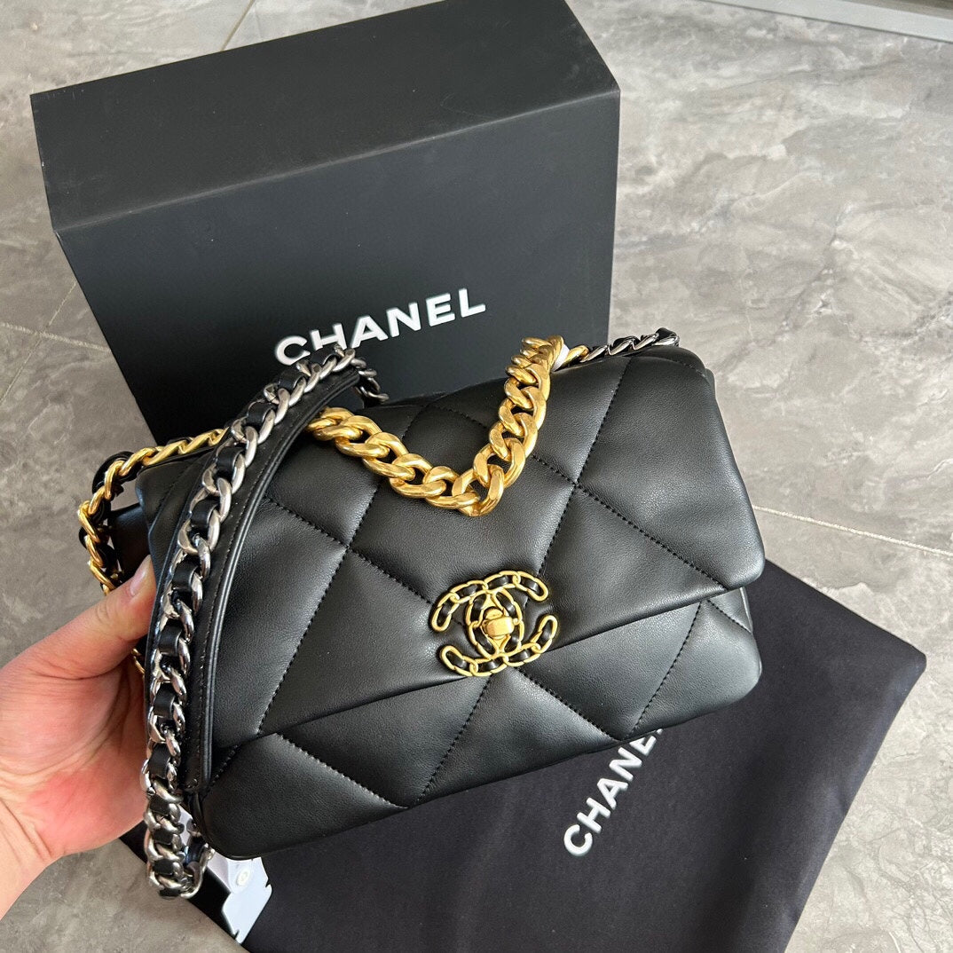 The classic Chanel 19 bag, featuring black and gold color scheme with a red interior, exudes both delicacy and grandeur, making it a must-have for every lady's collection.