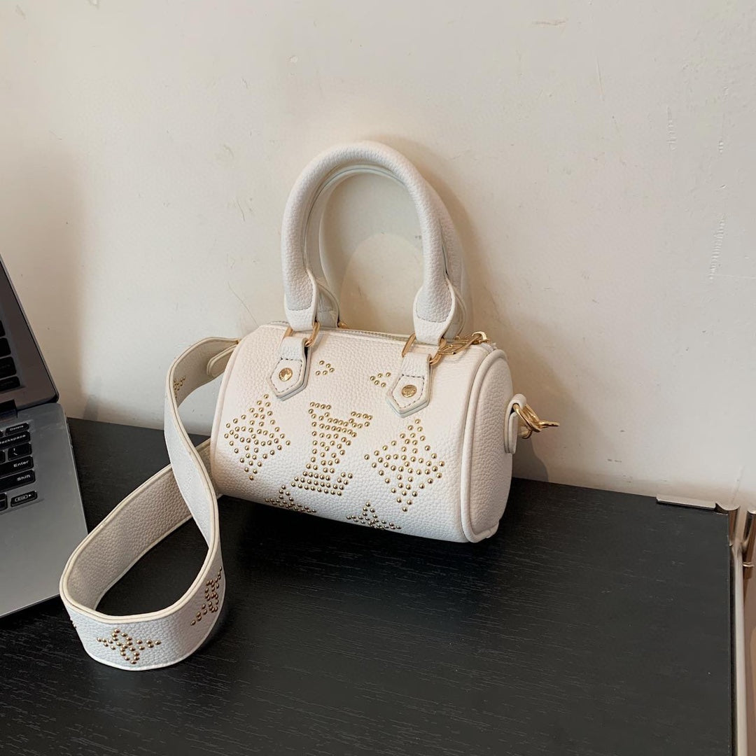 Small-sized studded Boston women's bag, available in two different colors, versatile and stylish.